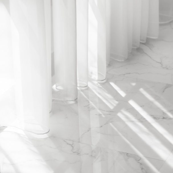 White marble floors with white linen curtains