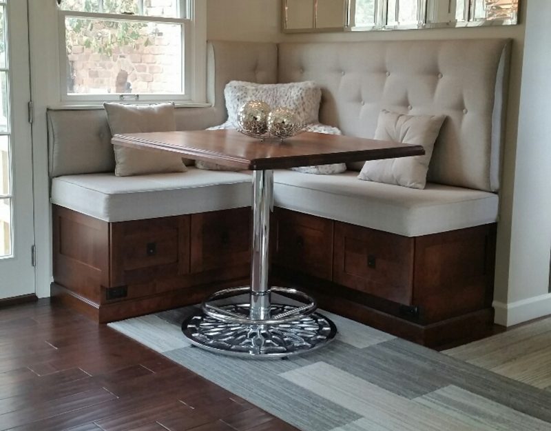 A chrome counter height table base in a residential kitchen booth. 